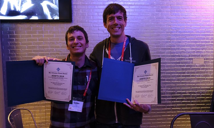 Galen Weld and Jon Froehlich holding the awards
