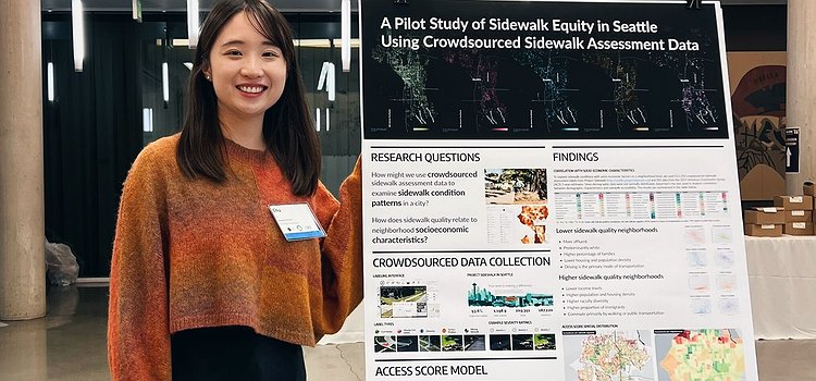 Chu Li standing in front of our sidewalk equity poster at the PacTrans conference