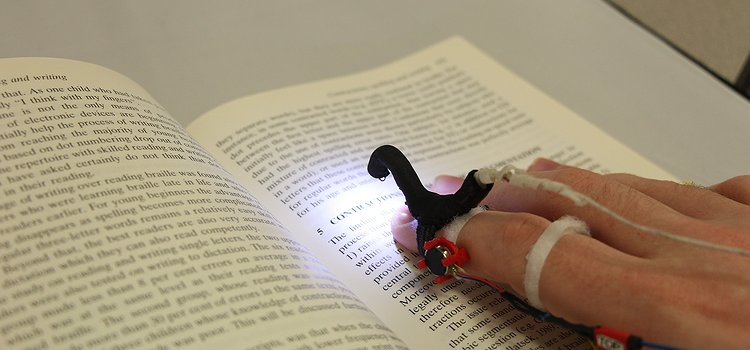 An early HandSight prototype for reading printed text