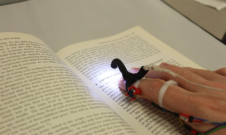 An early HandSight prototype for reading printed text