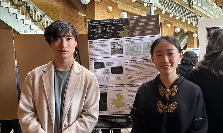 Joseph and Wenjing standing in front of our poster
