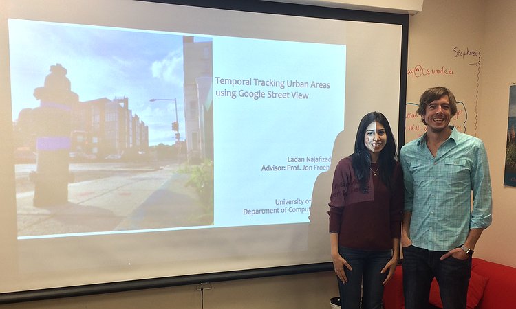 Ladan and Jon standing in front of Ladan's thesis proposal slides