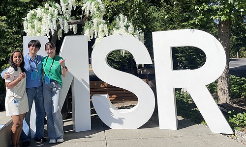 Arnavi, Chu, and Jae standing outside an MSR sign on the Microsoft Remond campus