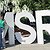 Arnavi, Chu, and Jae standing outside an MSR sign on the Microsoft Remond campus