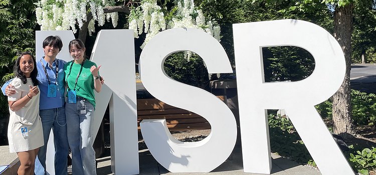 Arnavi, Chu, and Jae standing outside an MSR sign on the Microsoft Remond campus
