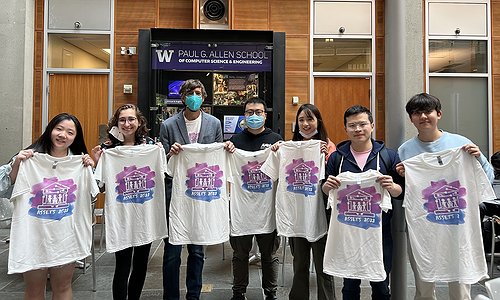 A picture of UW students holding up ASSETS'22 t-shirts. From left-to-right in the photo , Judy Kong, Kelly Mack, Jon E. Froehlich, Zhuohao (Jerry) Zhang, Chu Li, Xia Su, and Jaewook Lee.