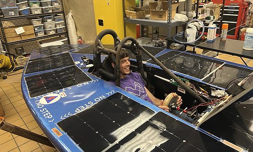 Jon sitting in the solar car vehicle