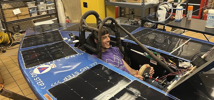 Jon sitting in the solar car vehicle
