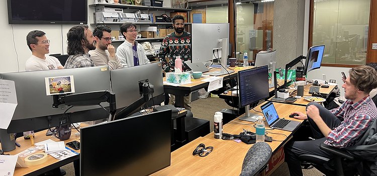 Mikey working in the UbiComp Lab and a set of students watching the World Cup