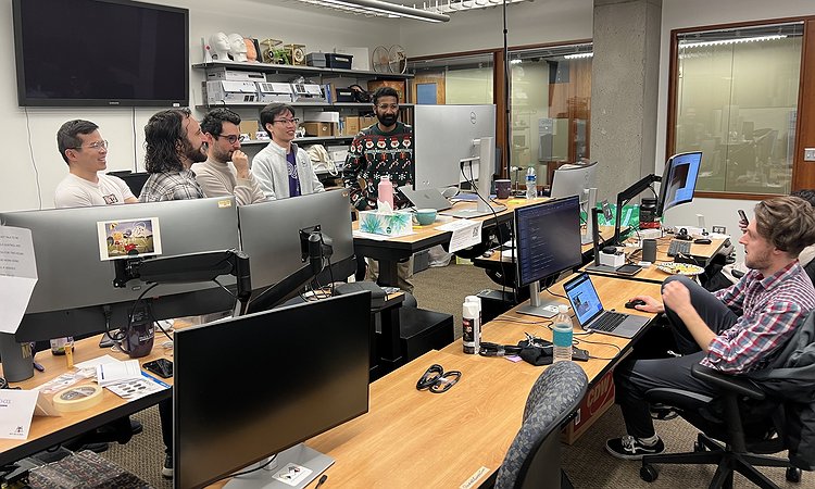 Mikey working in the UbiComp Lab and a set of students watching the World Cup