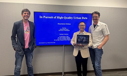 The dissertation committee standing in front of Bin's title slide