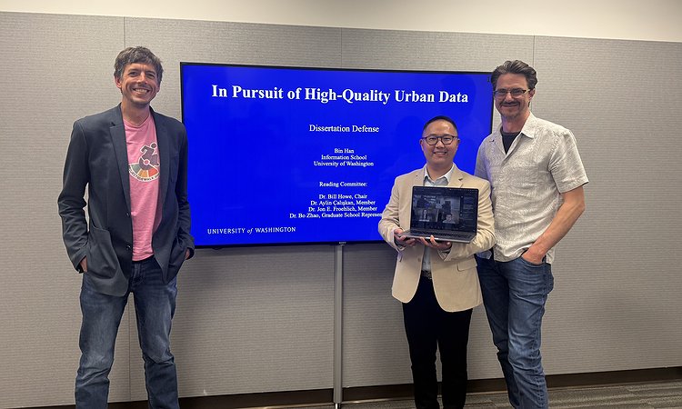 The dissertation committee standing in front of Bin's title slide