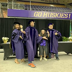 An image of Manaswi, Jon, Aileen, and Liang in their graduation gowns and making silly faces