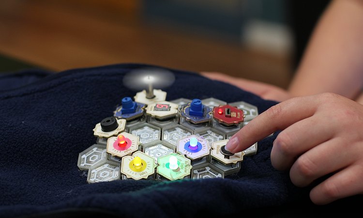 A child building an interactive wearable vest