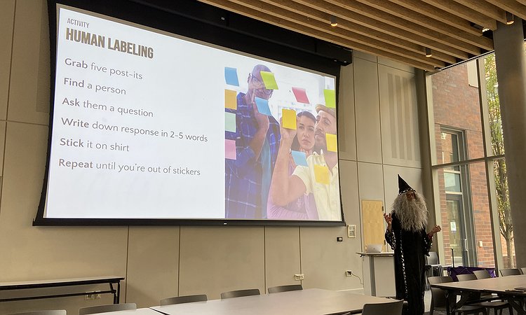 Professor Froehlich dressed up as Dumbledore and speaking at the MHCI+D Fall Workshop