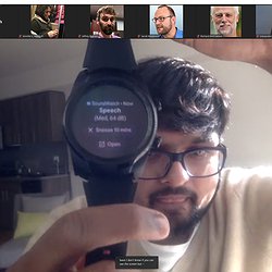 DJ holding an Android watch running SoundWatch that shows Speech has been recognized (at 64 dB). The alert can be snoozed for 10 minutes