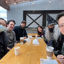An image showing Makeability Lab members sitting around a table with coffee at Saint Bread