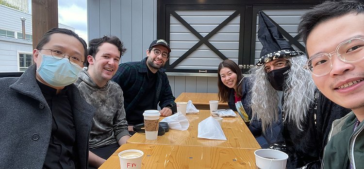 An image showing Makeability Lab members sitting around a table with coffee at Saint Bread