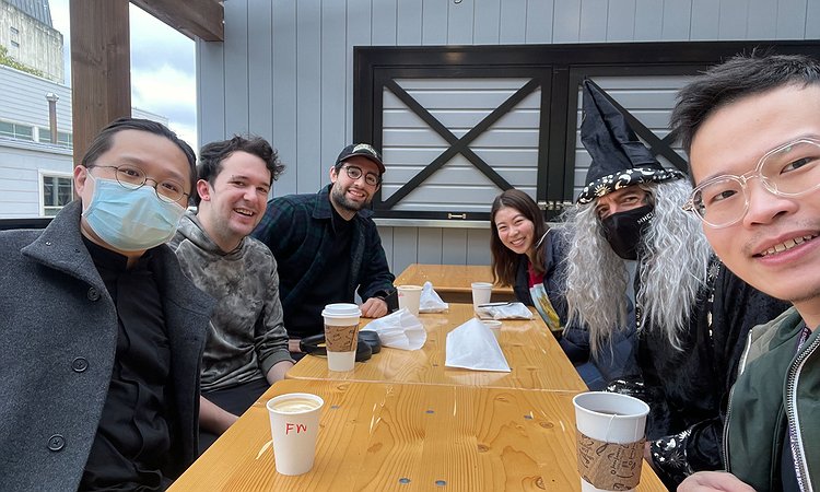An image showing Makeability Lab members sitting around a table with coffee at Saint Bread