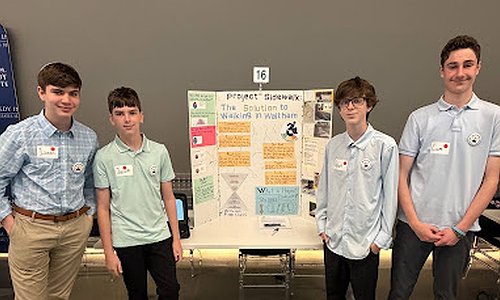 The four students representing McDevitt Middle School at the state-wide competition. They are standing in front of their poster