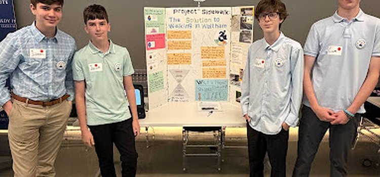 The four students representing McDevitt Middle School at the state-wide competition. They are standing in front of their poster