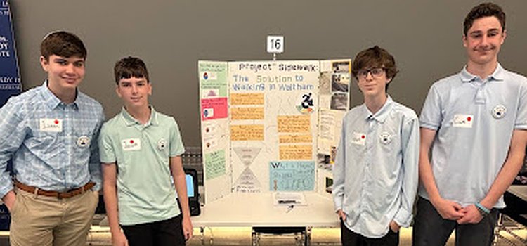 The four students representing McDevitt Middle School at the state-wide competition. They are standing in front of their poster