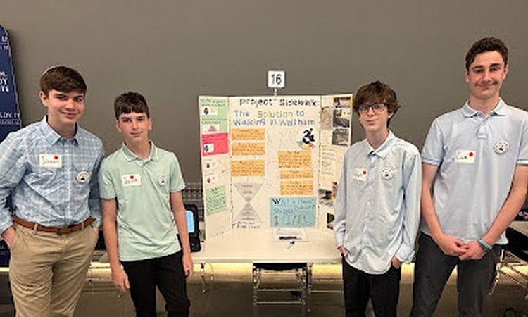 The four students representing McDevitt Middle School at the state-wide competition. They are standing in front of their poster