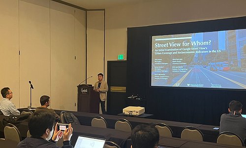 Zeyu presenting at ACM GeoIndustry with his title slide behind him