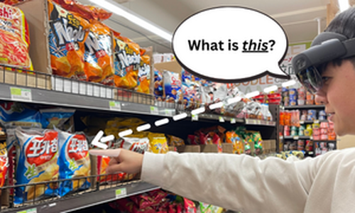An image of Jae wearing the HoloLens 1 and pointing to a bag of chips in a grocery aisle asking "What is this?"