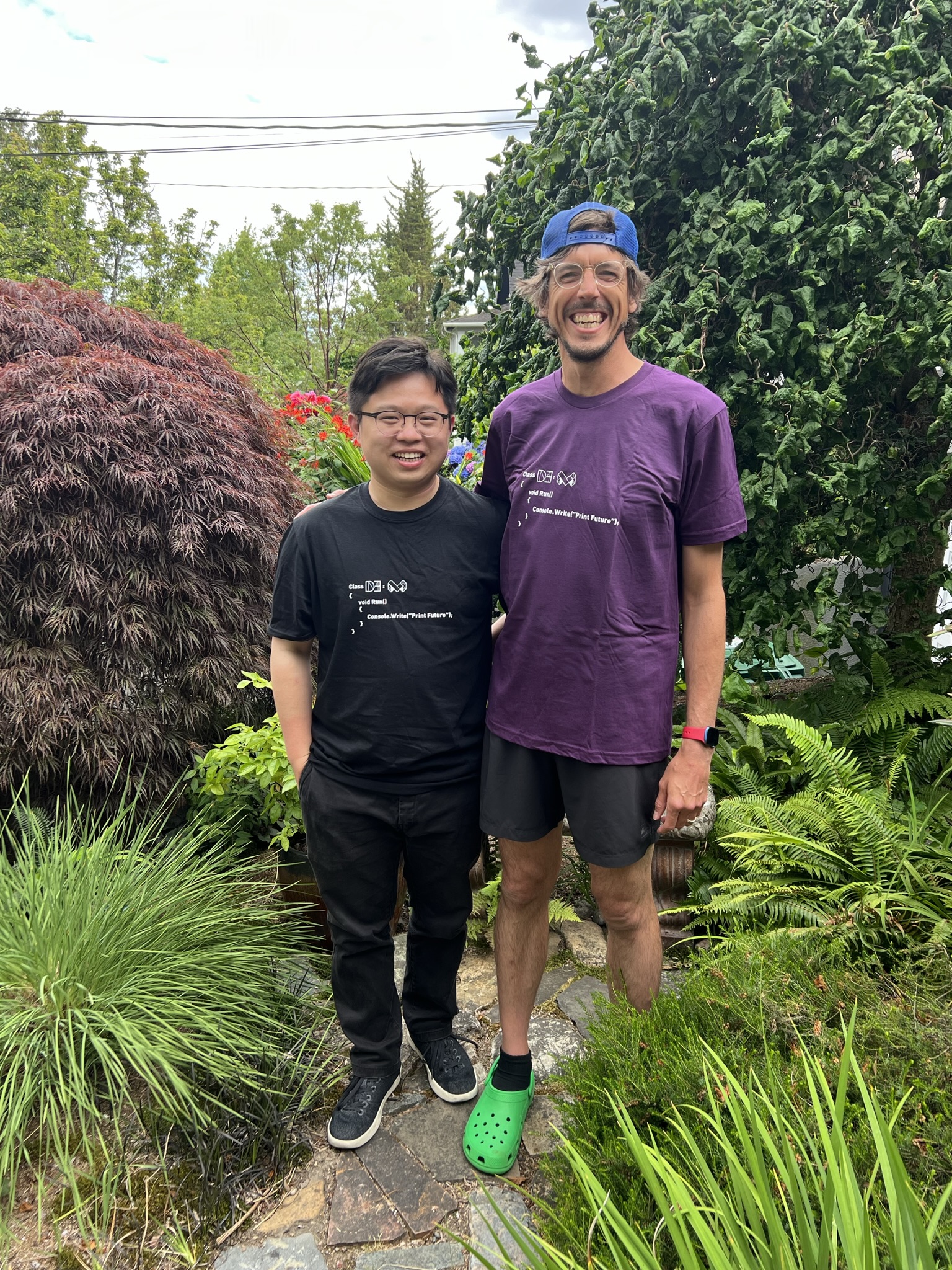 A picture of Liang and Jon standing together in our new t-shirts