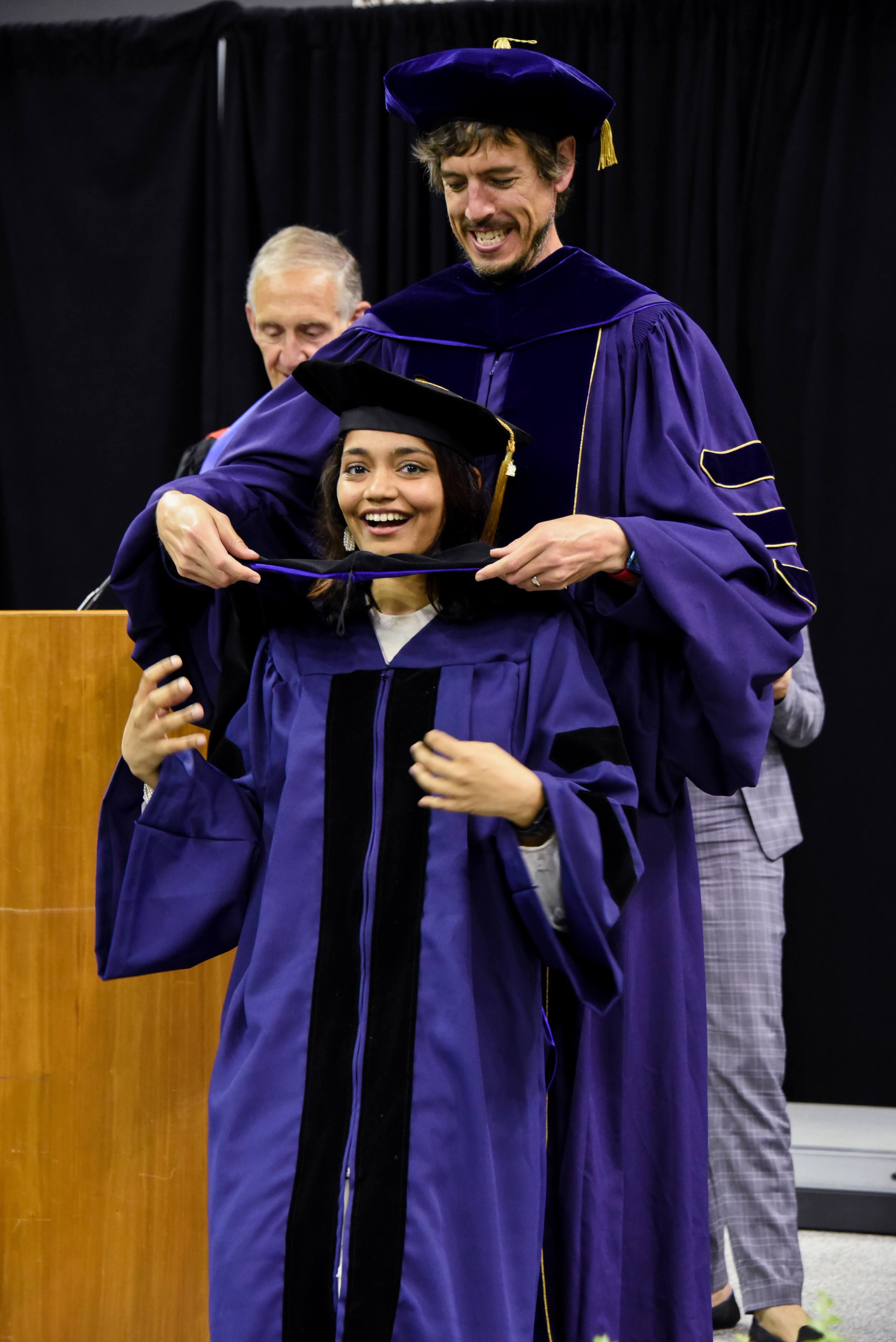 Jon hooding Manaswi at the graduation ceremony