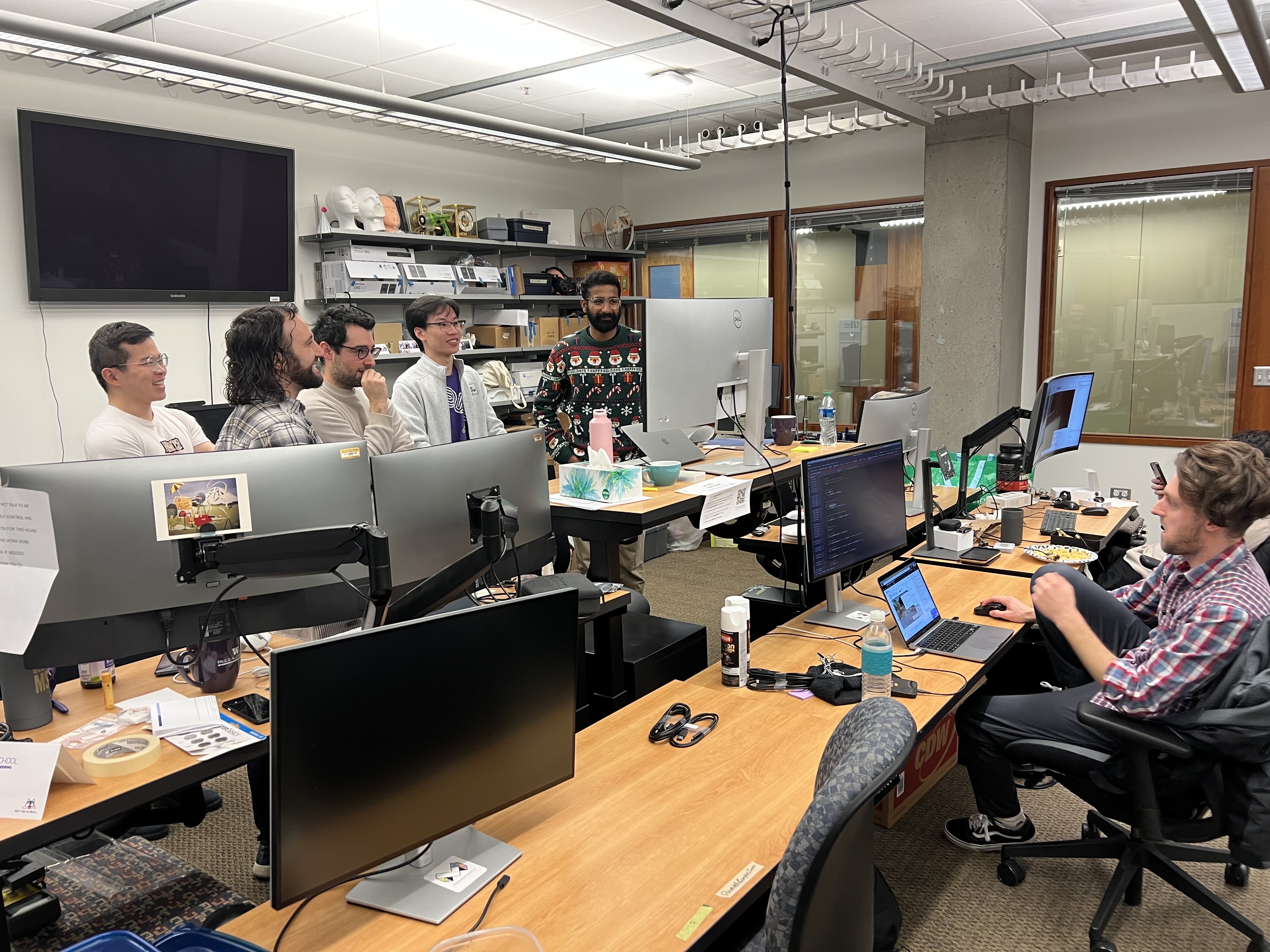 Mikey working in the UbiComp Lab with others watching World Cup