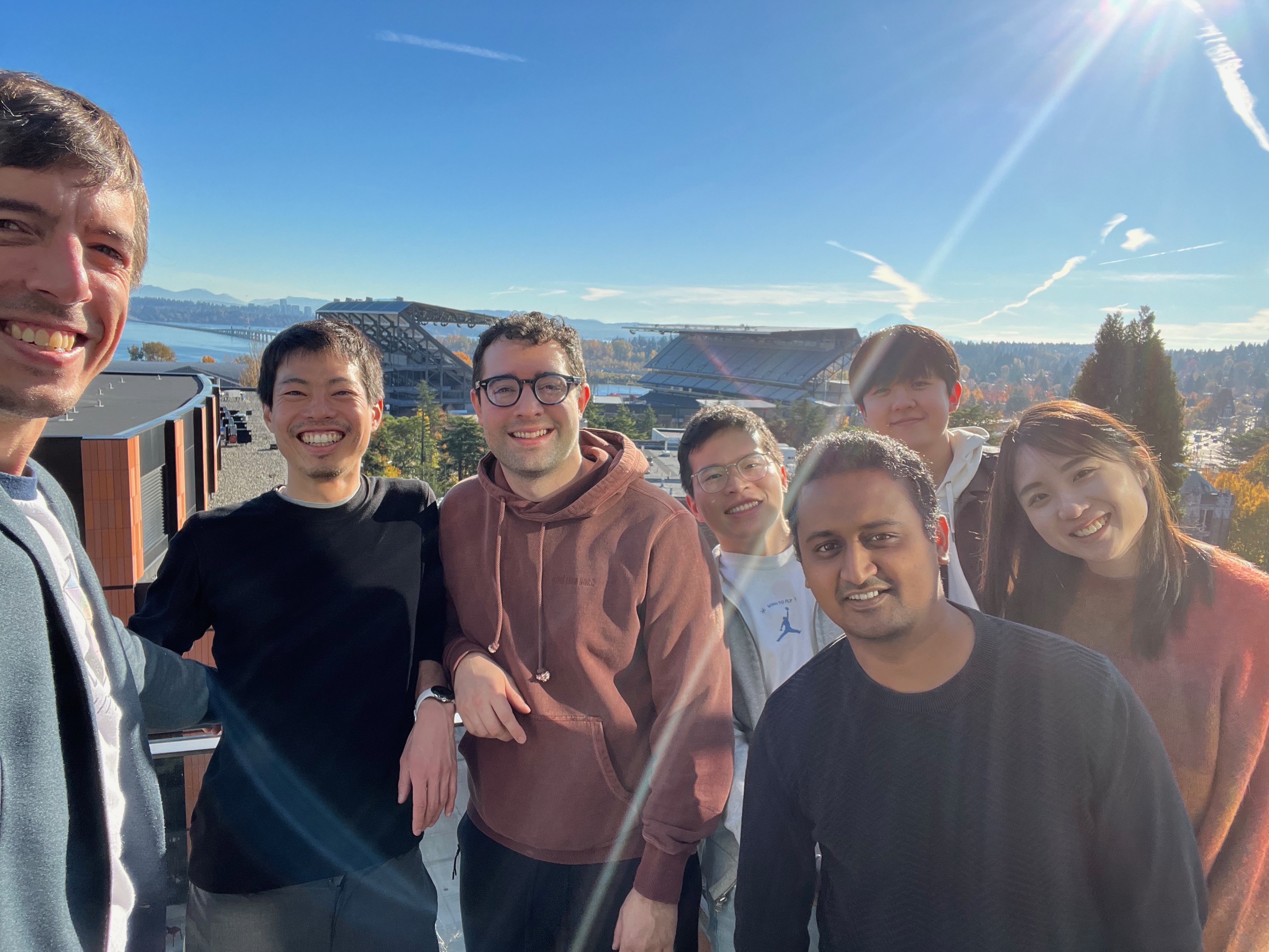 Makeability Lab takes a selfie with Ryo with the Cascades and Lake Washington in the background