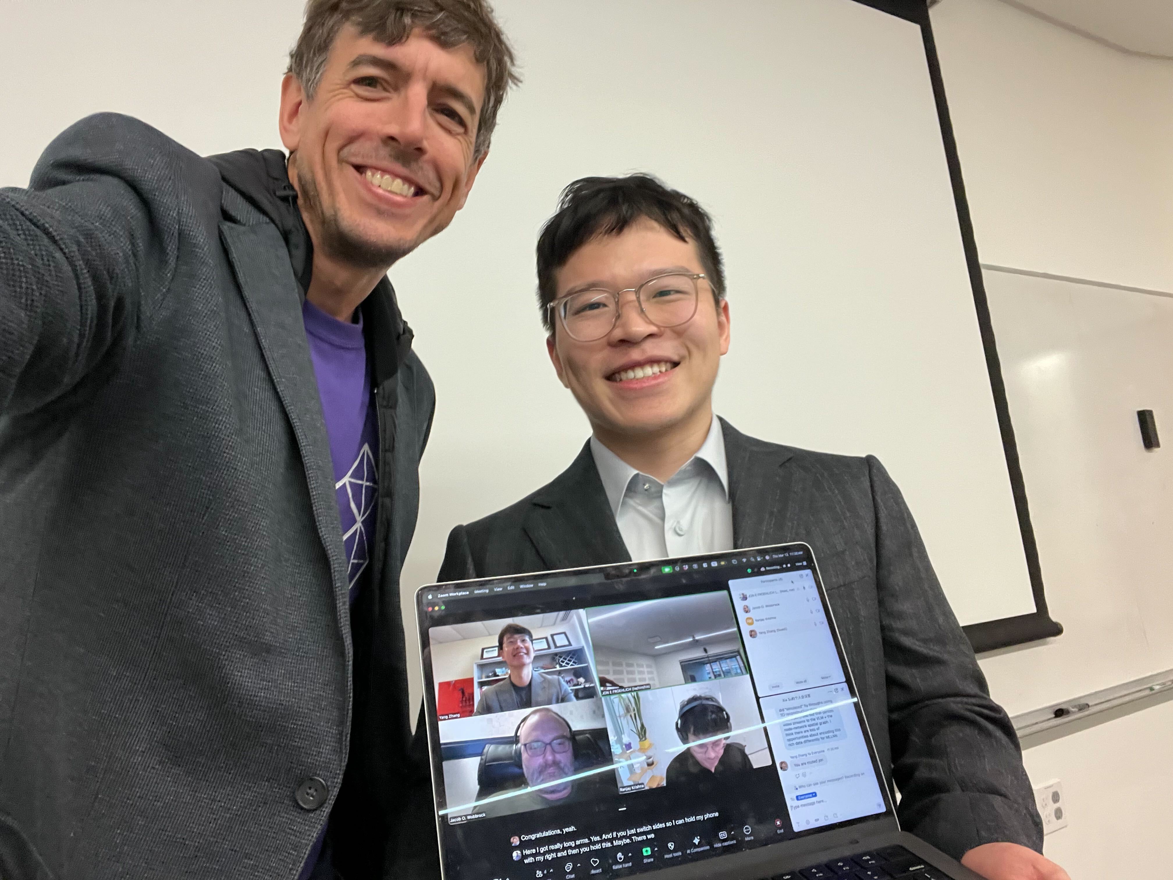 A picture of Jon, Xia, and the rest of the committee, whcih are on the laptop